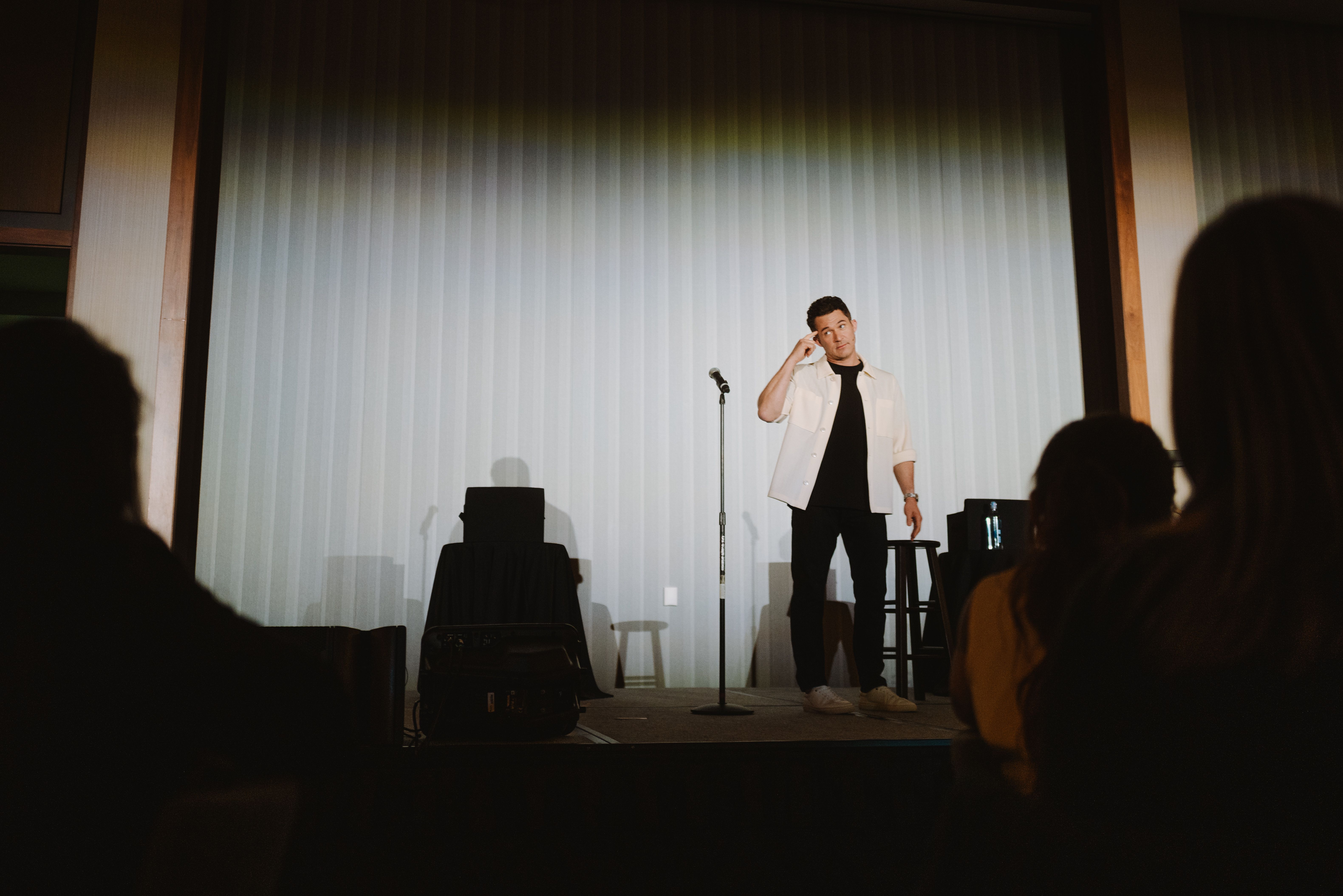 Justin Willman onstage at The Summit doing his magic performance