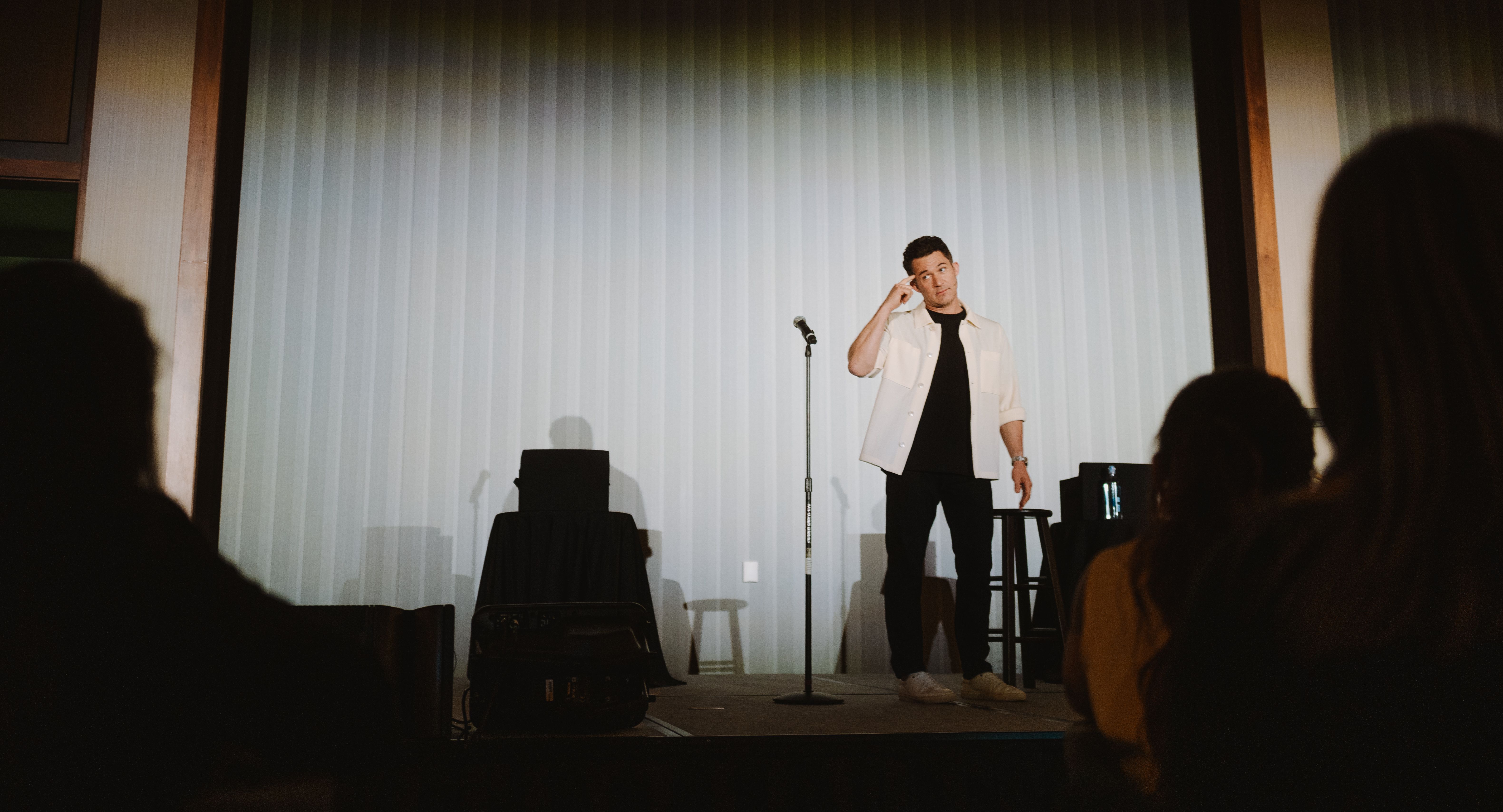 Justin Willman onstage at The Summit doing his magic performance