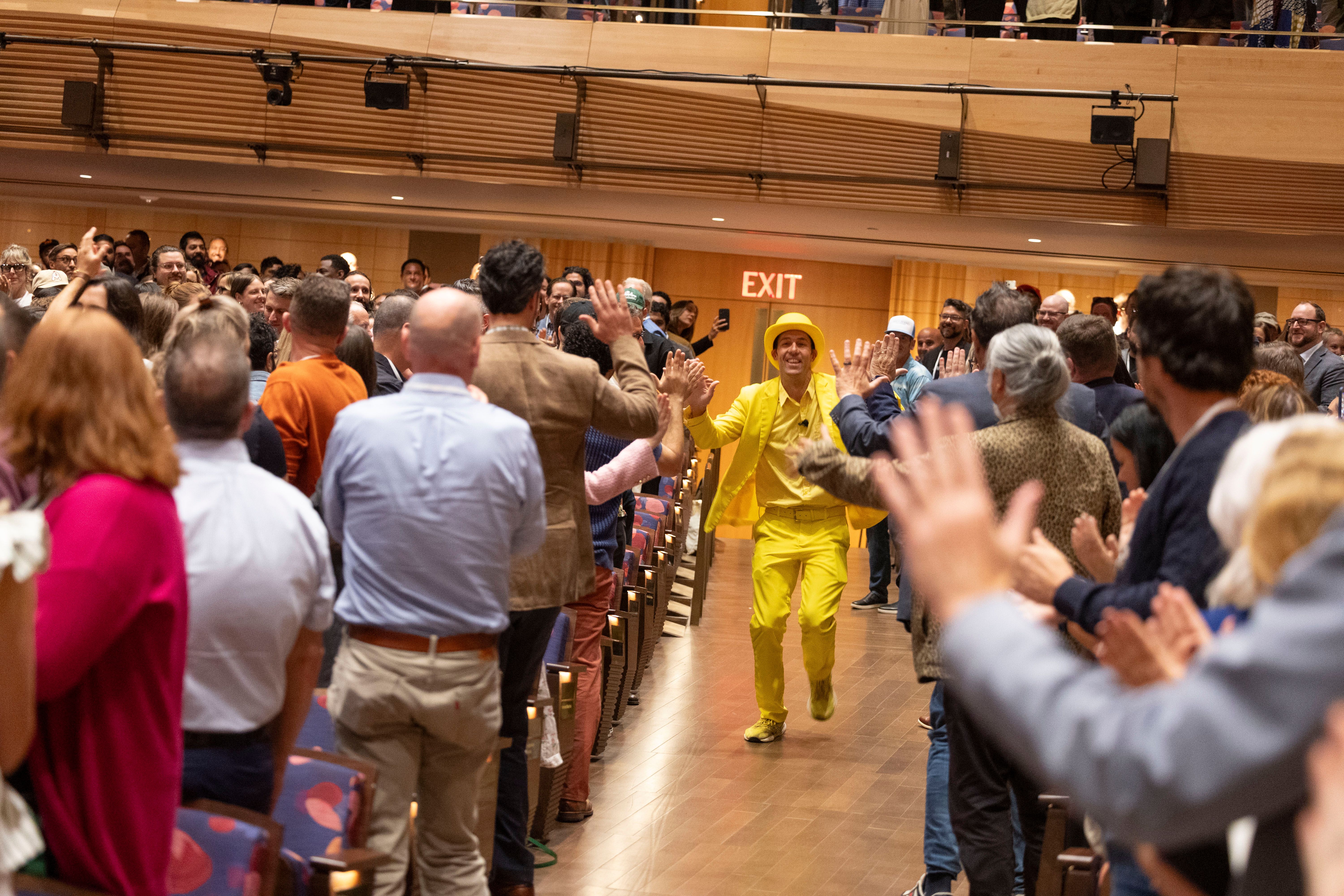 Jesse Cole running up the aisle at Welcome