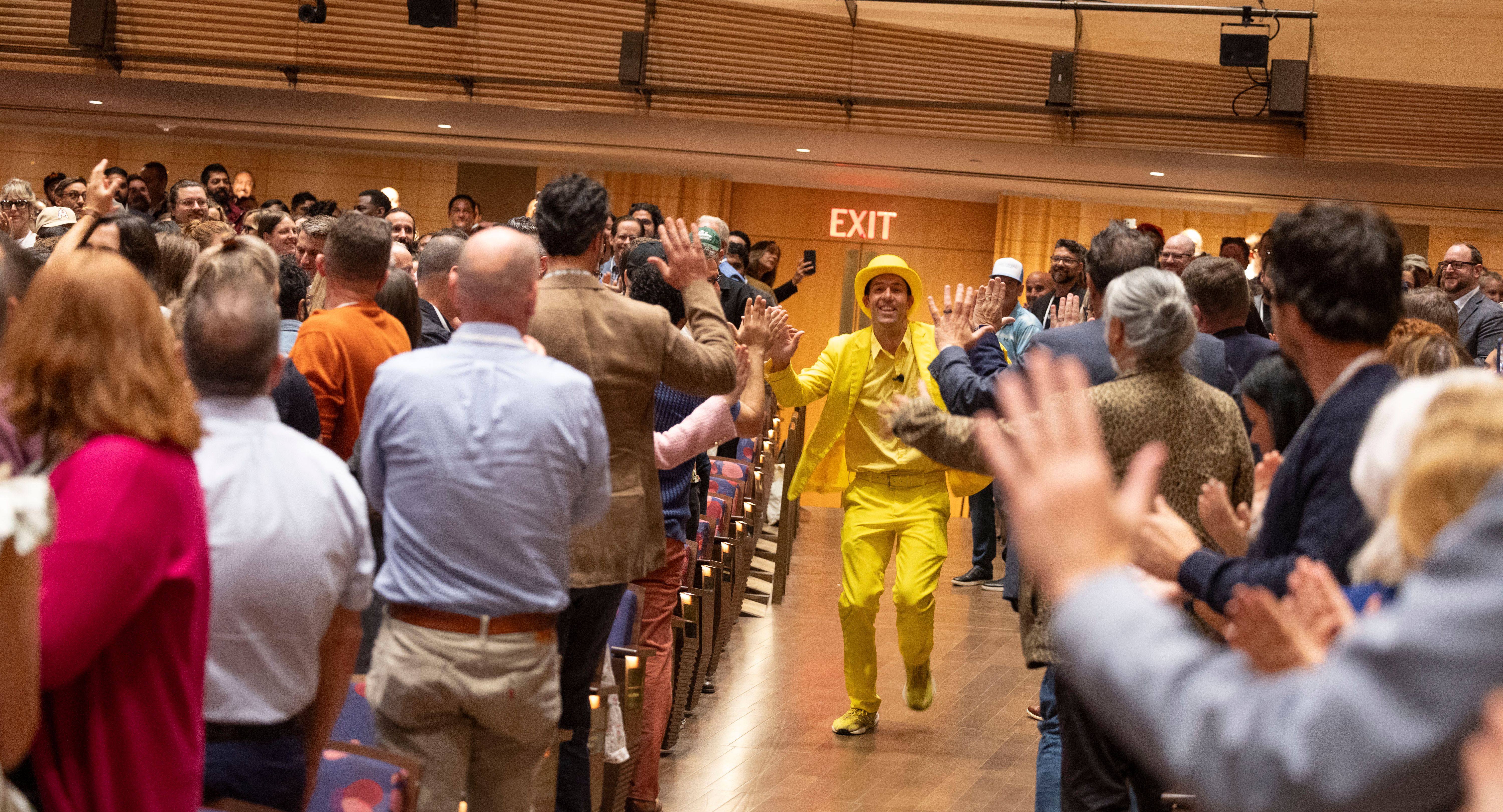 Jesse Cole running up the aisle at Welcome
