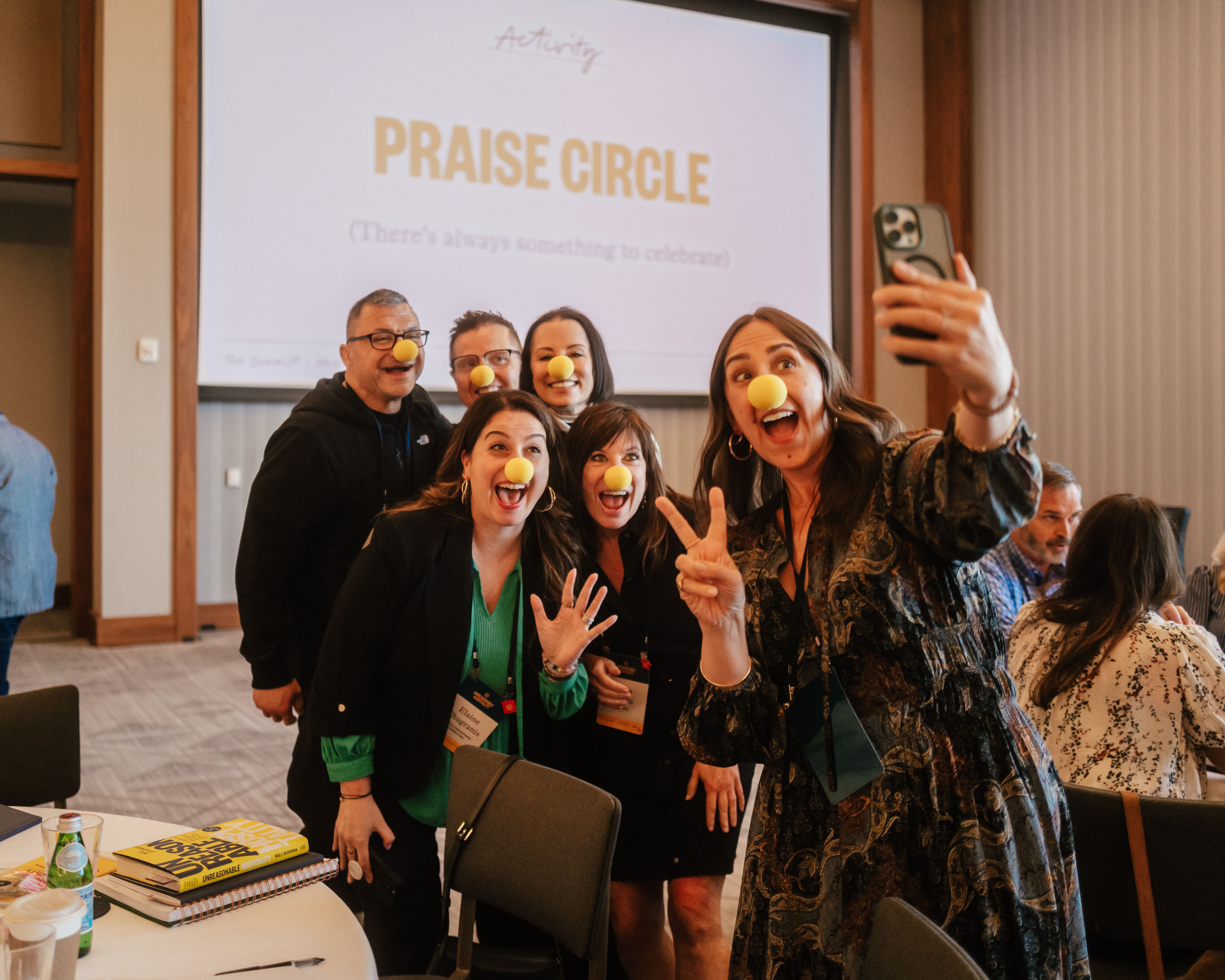 The Summit attendees posing for a selfie with clown noses