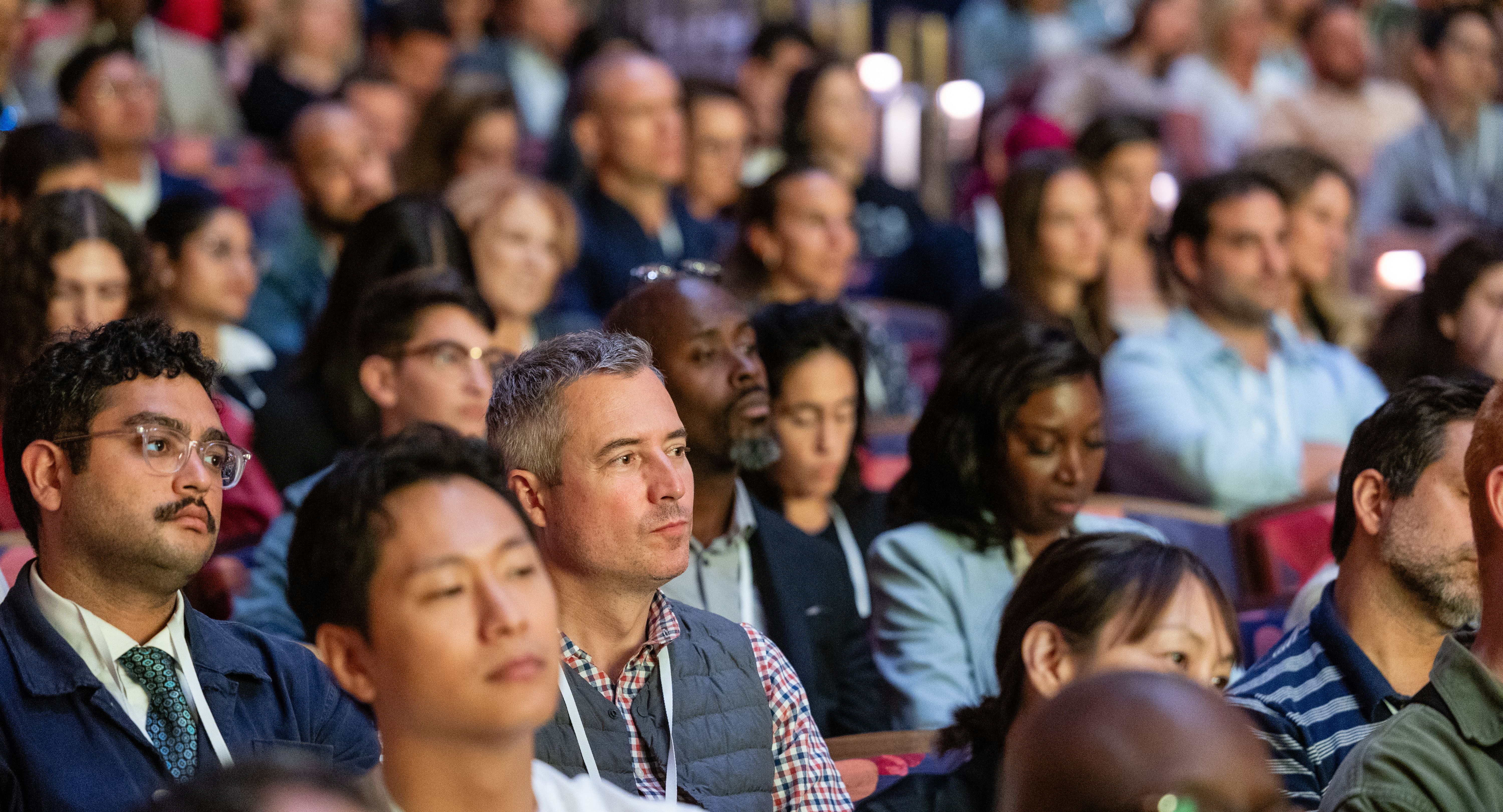 Audience at the Welcome Conference watching the stage
