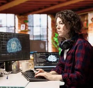 A learner working on a model at two screens