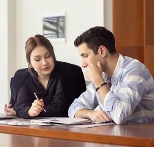 A mentor and a learner reviewing notes