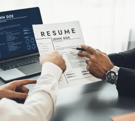 Two people reviewing a resume