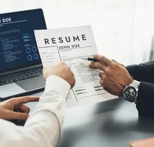 Two people reviewing a resume