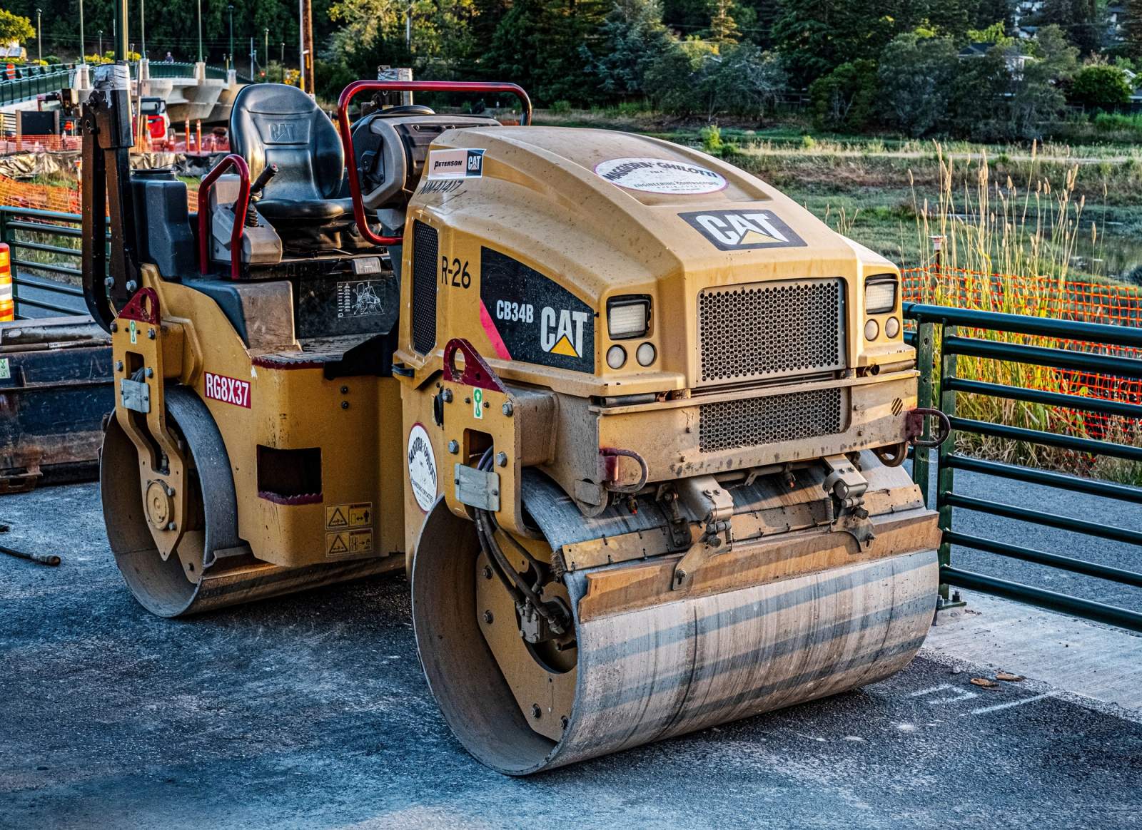 CAT asphalt roller used with paving equipment