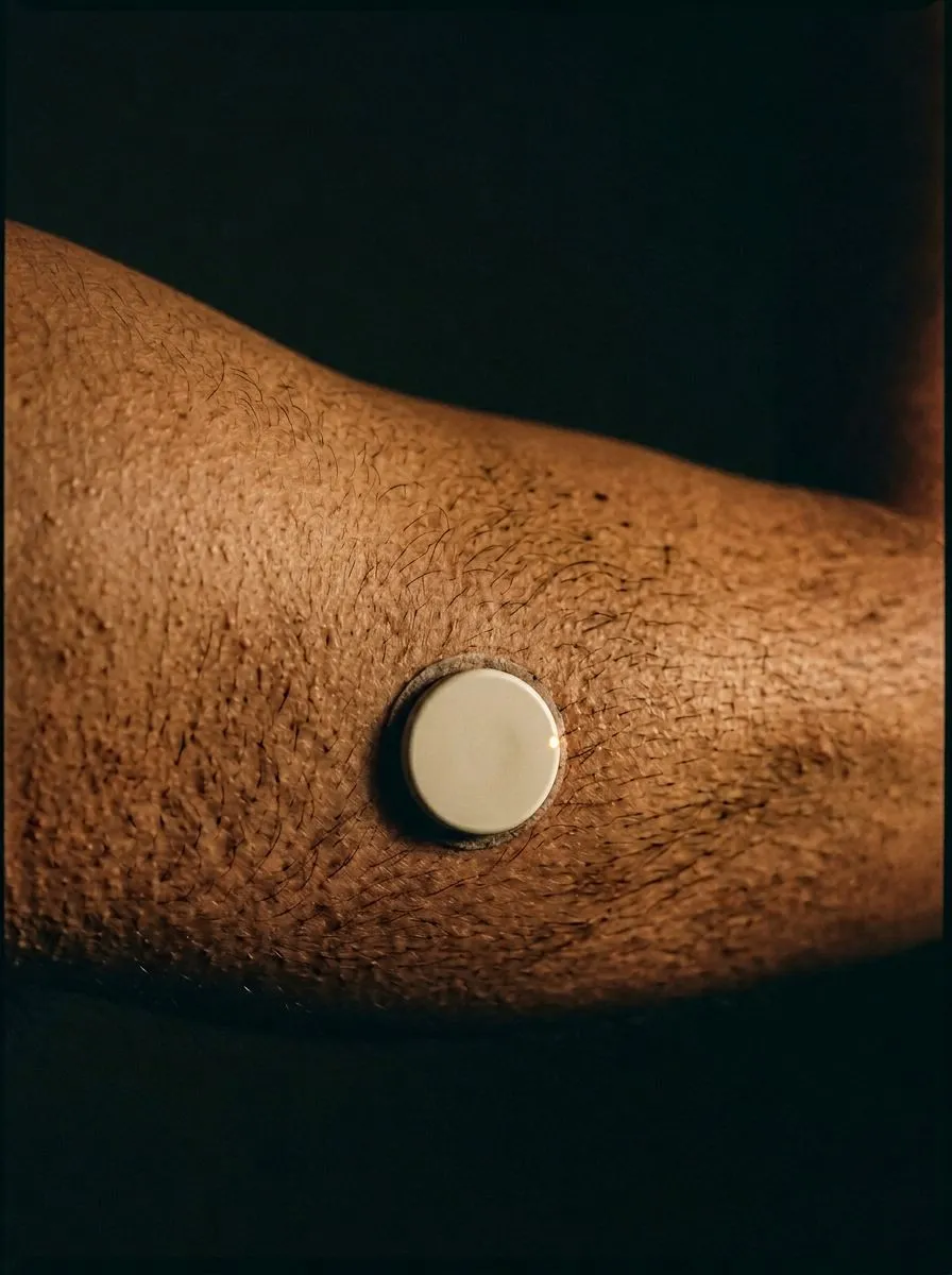 Continuous glucose monitor sensor on the back of an arm