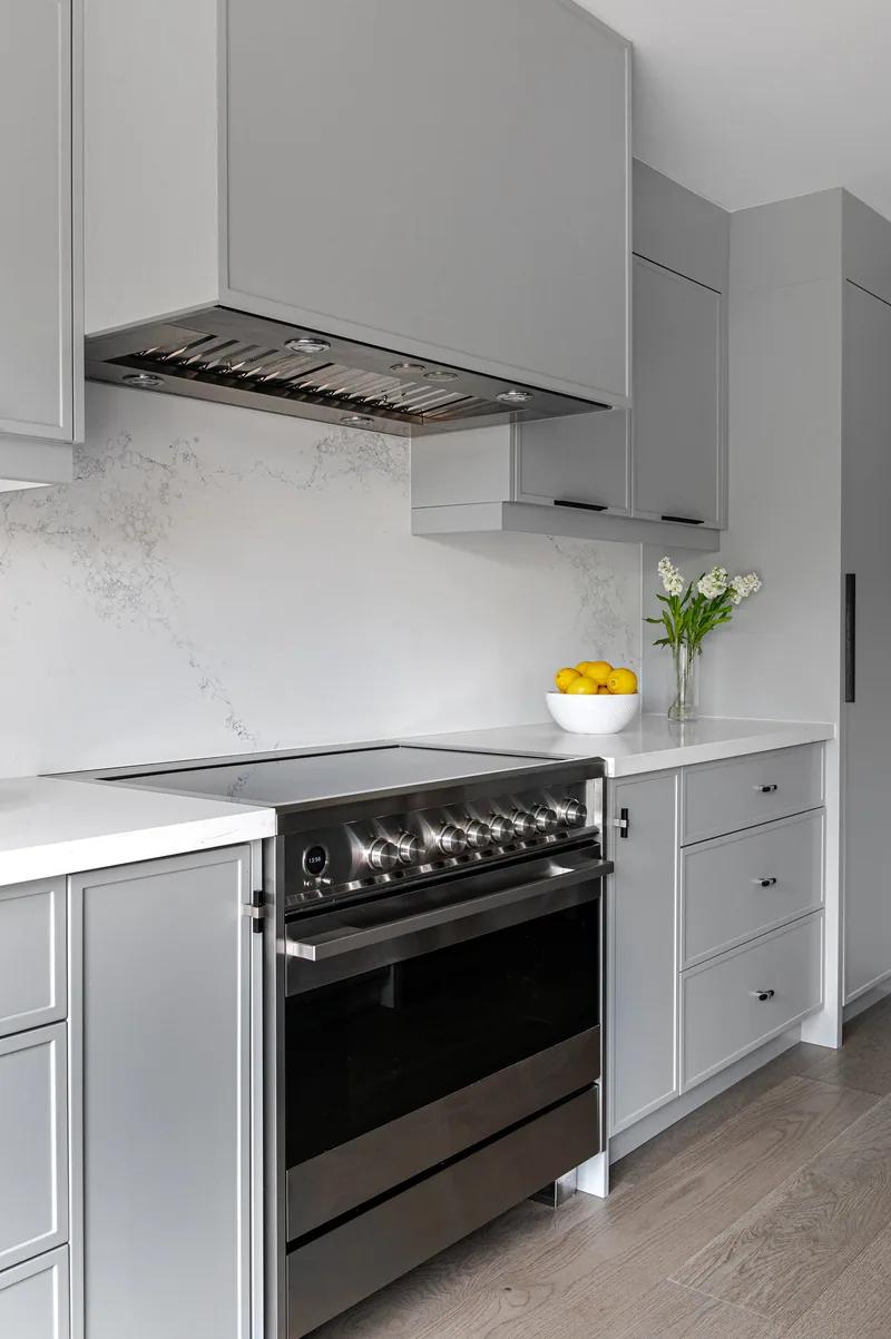 A range under a grey hood, a marble slab behind it