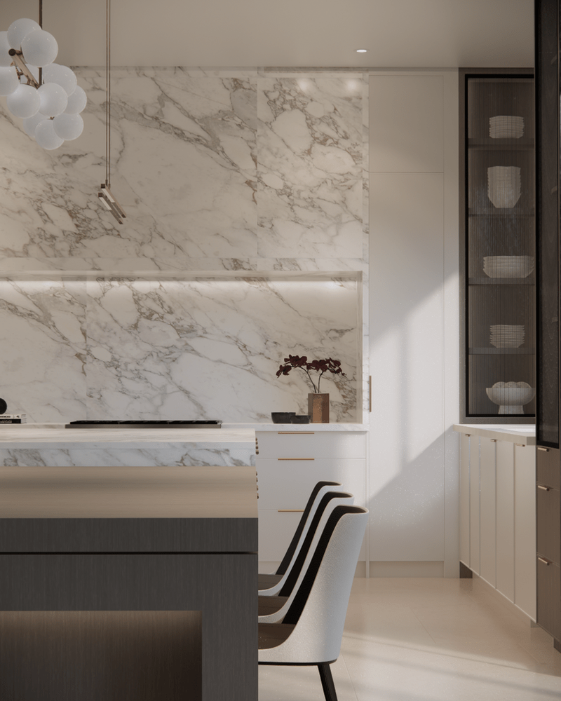 A marble backsplash and counter against white cabinetry, a dark wood island in front