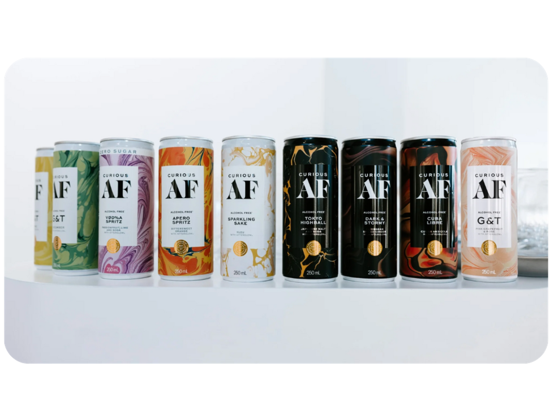 Several cans of Curious AF, a non-alcoholic beverage by AF Drinks, lined up on a shelf
