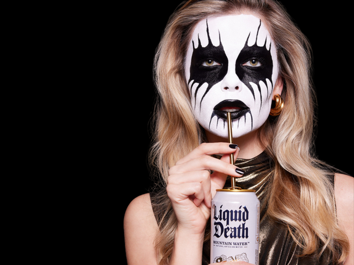 Woman drinking Liquid Death water