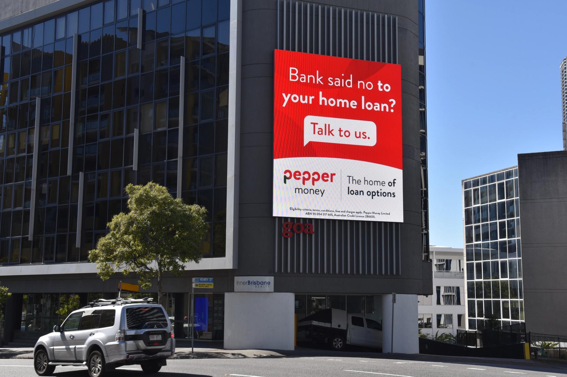 Large billboard displaying Pepper Money's advertisement as part of their multi-channel marketing campaign on the side of a building