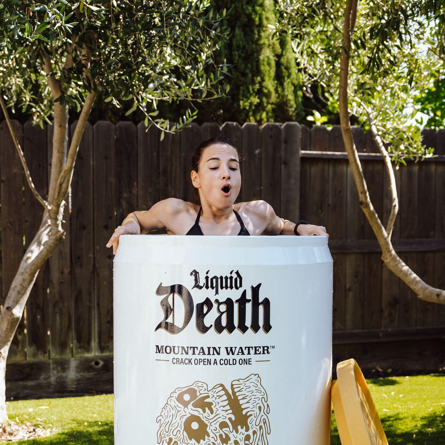 A woman swimming in an oversized can of Liquid Death, symbolizing the brand's bold and unconventional marketing strategies
