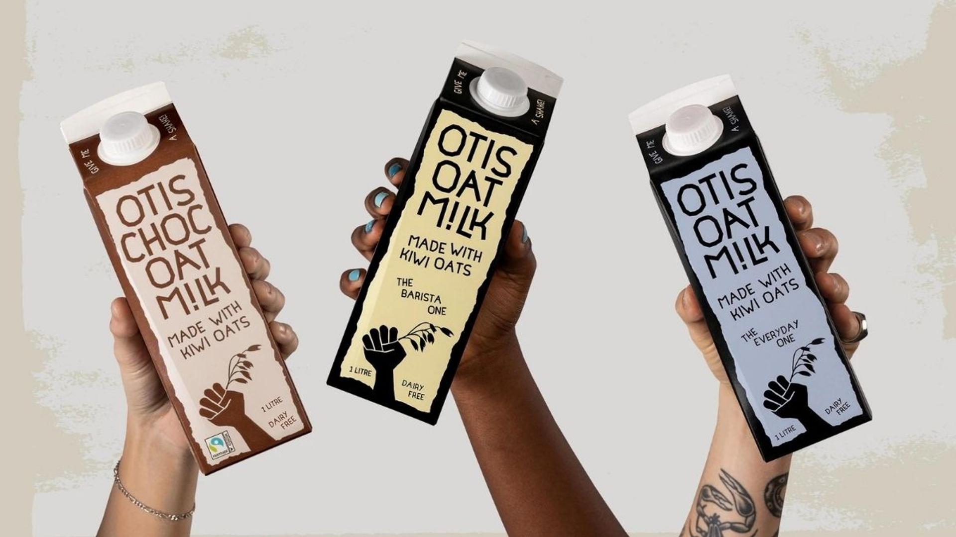 Three people holding bottles of oat milk for improving brand performance