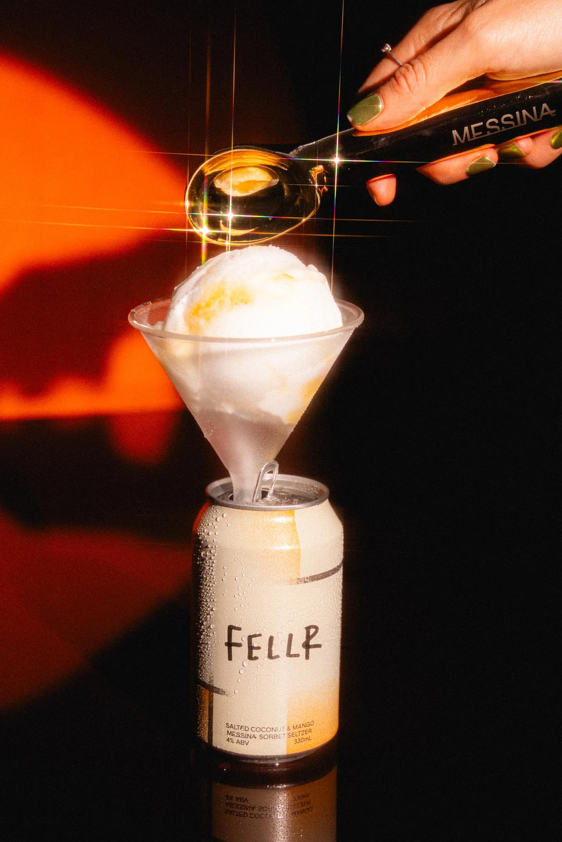 Ice cream served in a martini glass, which is creatively placed inside a FELLR can, representing the collaboration between FELLR and Messina for unique seltzer and ice cream flavors.