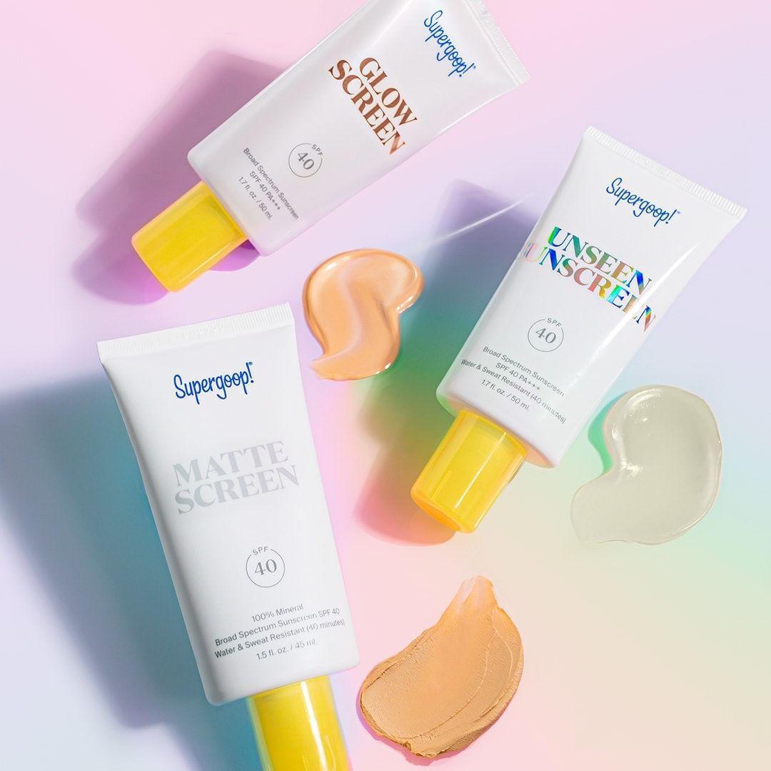 supergoop product flatlay on multicolored pastel background