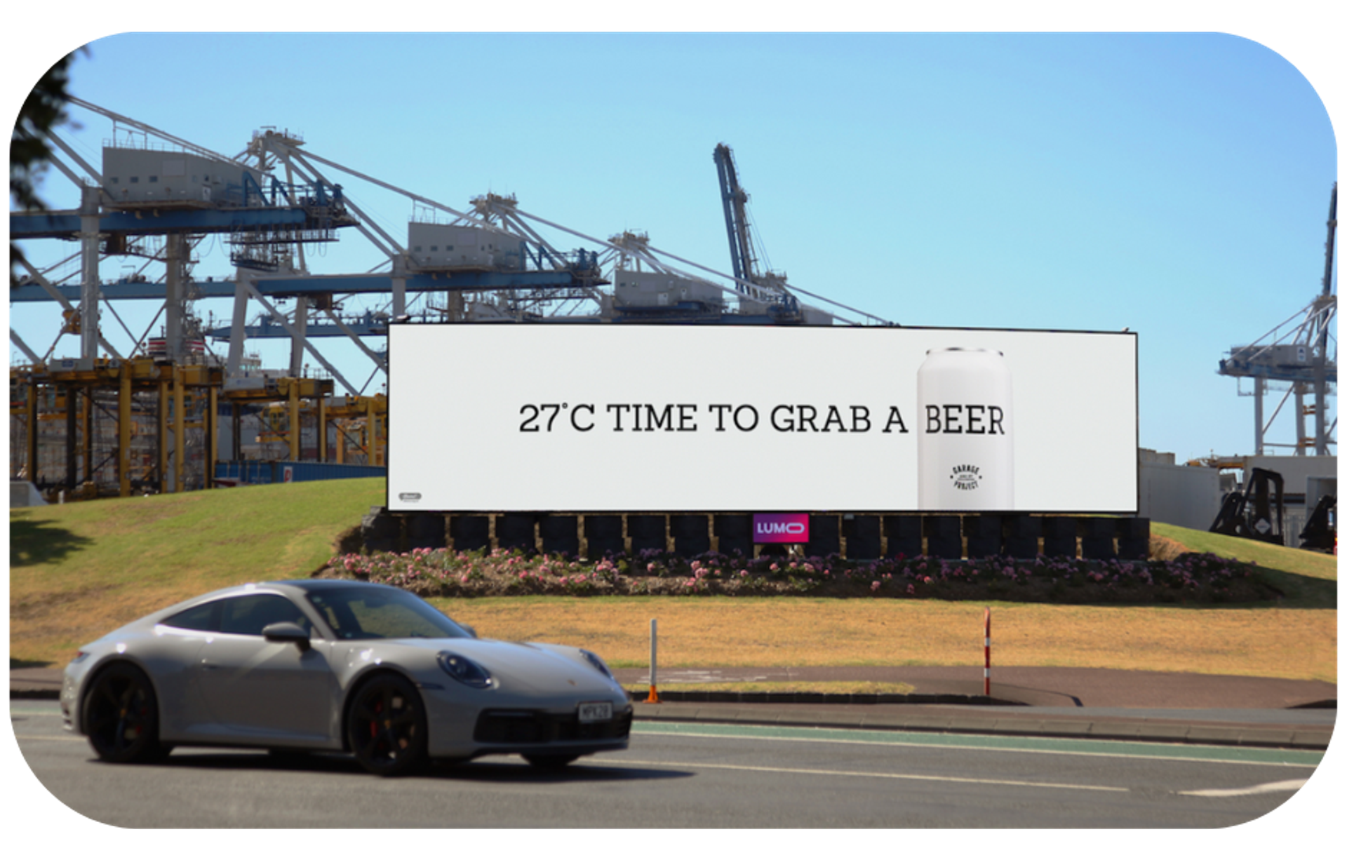 A digital billboard displaying a message '27 c time to grab a beer', indicating it's a perfect time for a refreshing beer due to the warm weather.