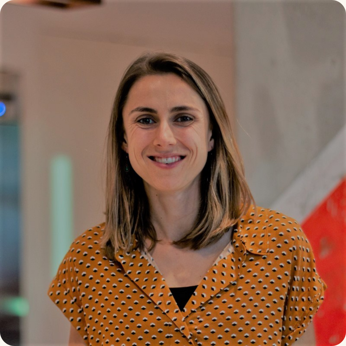 Meryl McCurry, Head of Brand Strategy at Reef, smiling at the camera in a polka dot shirt