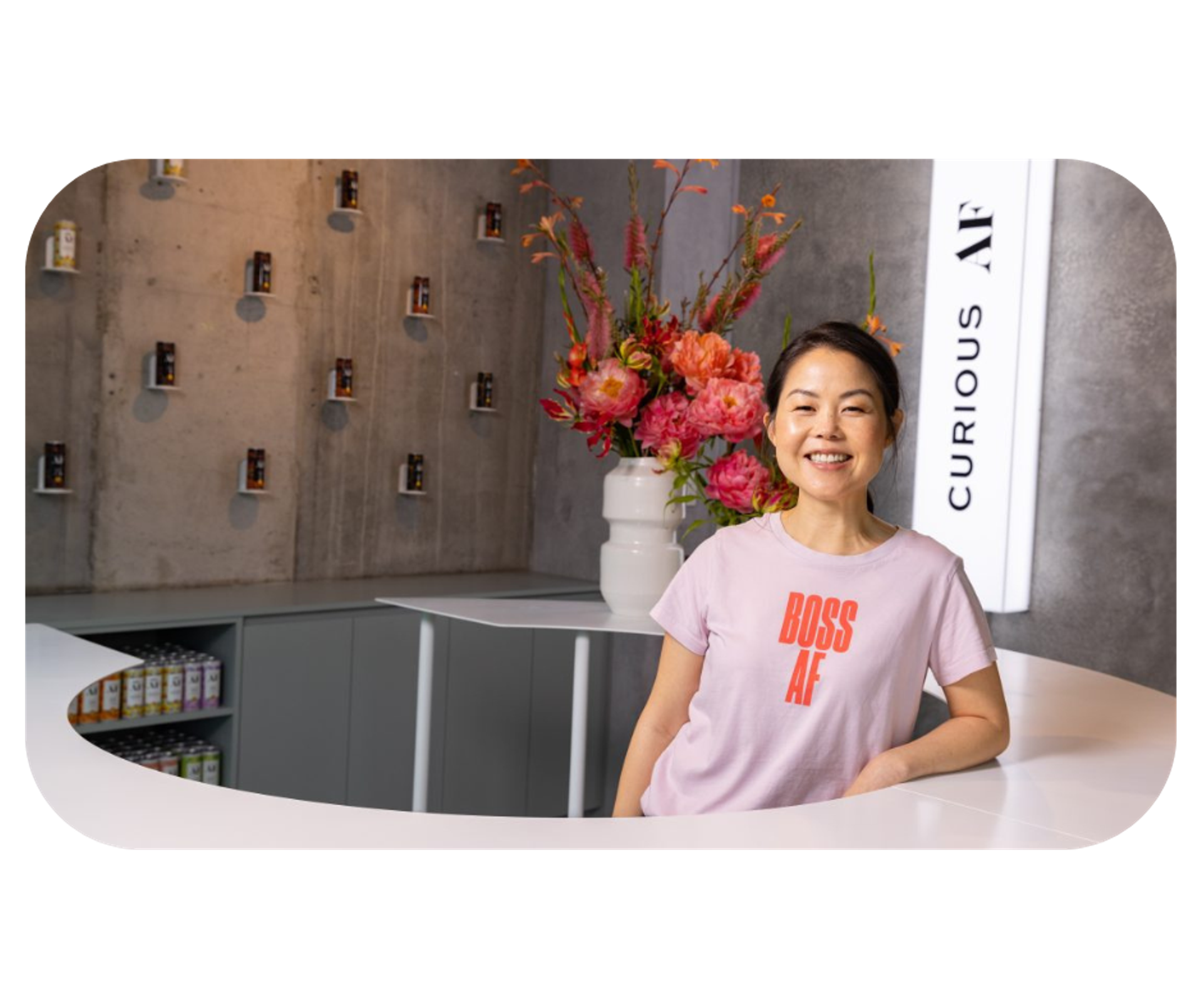 Lisa King, founder of AF Drinks, wearing a pink shirt with the text 'boss af', symbolizing her leadership in the non-alcoholic beverage industry