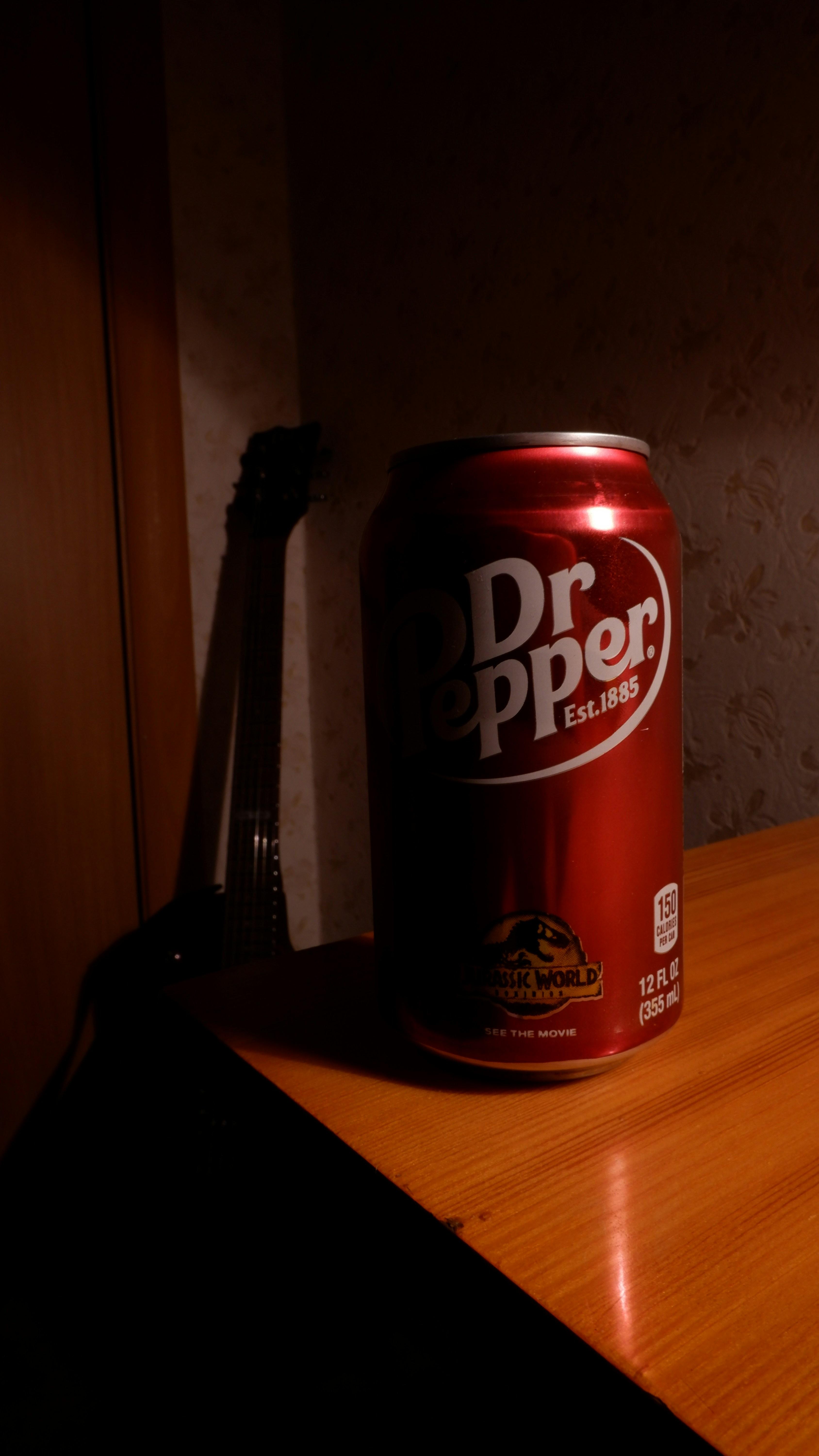 A can of Dr Pepper sits on a wooden table