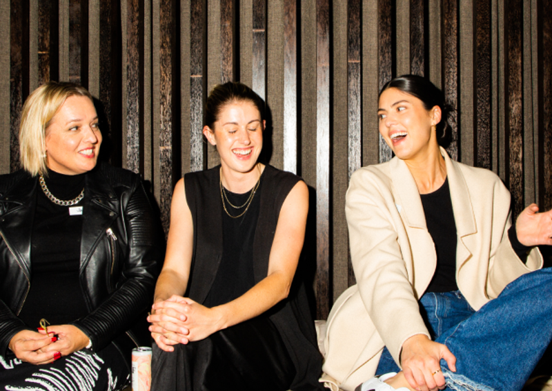 three women chatting side by side