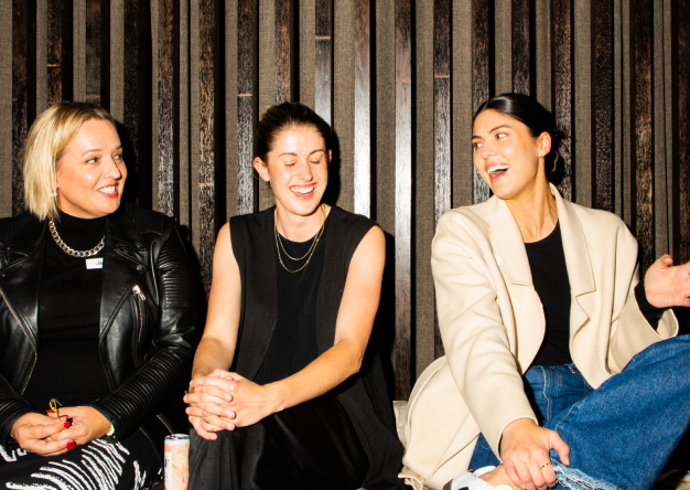 three women chatting side by side