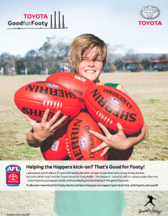 An advertisement for toyota good for footy shows a young boy holding three rugby balls.