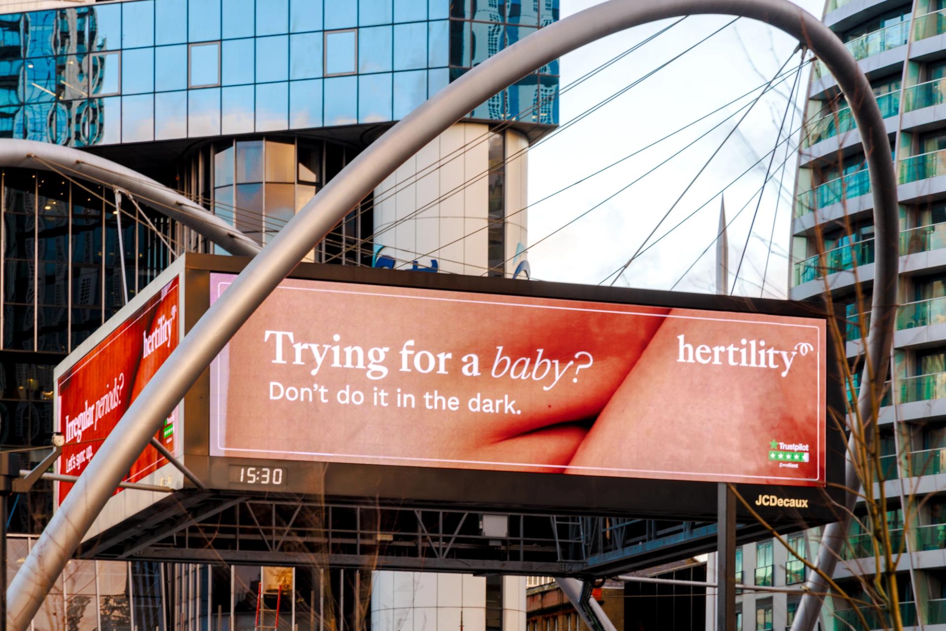 A billboard promoting Hertility, a brand advocating for women's health and reproductive education, with the text 'Trying for a baby' on it