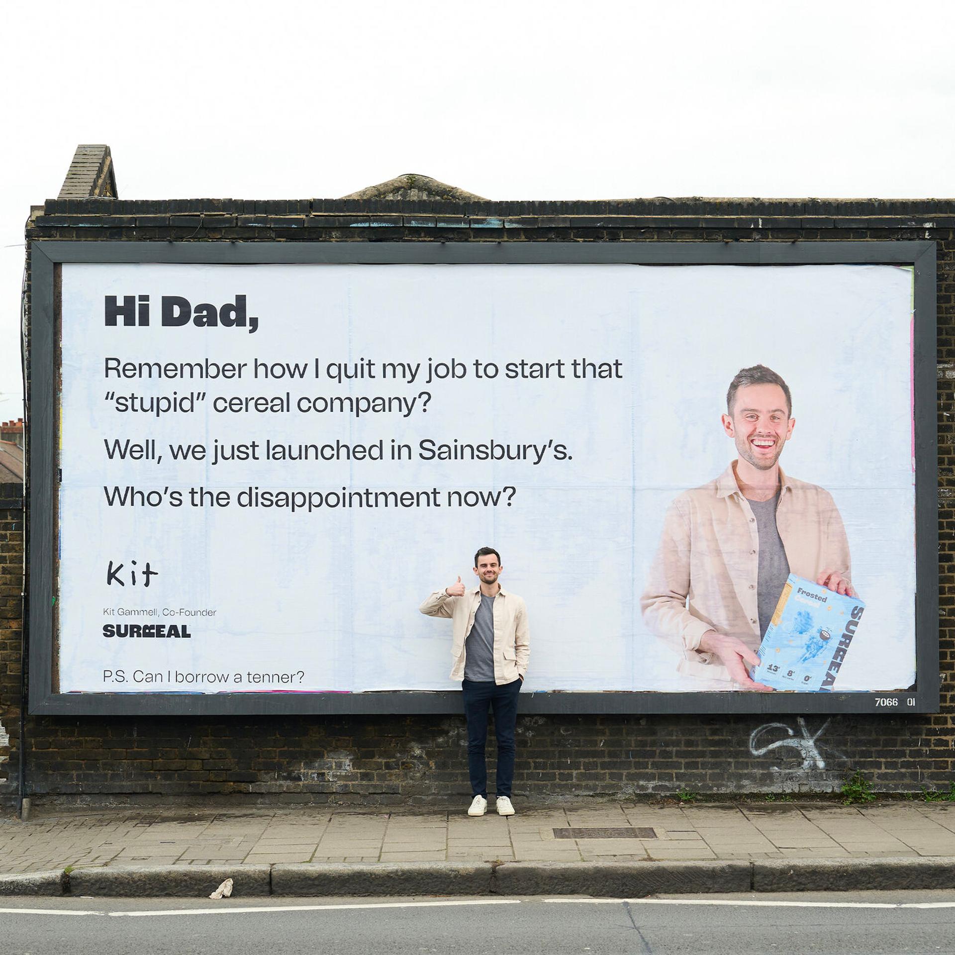 A man standing in front of a large billboard, representing the concept of brand voice and marketing strategies in the context of the article.