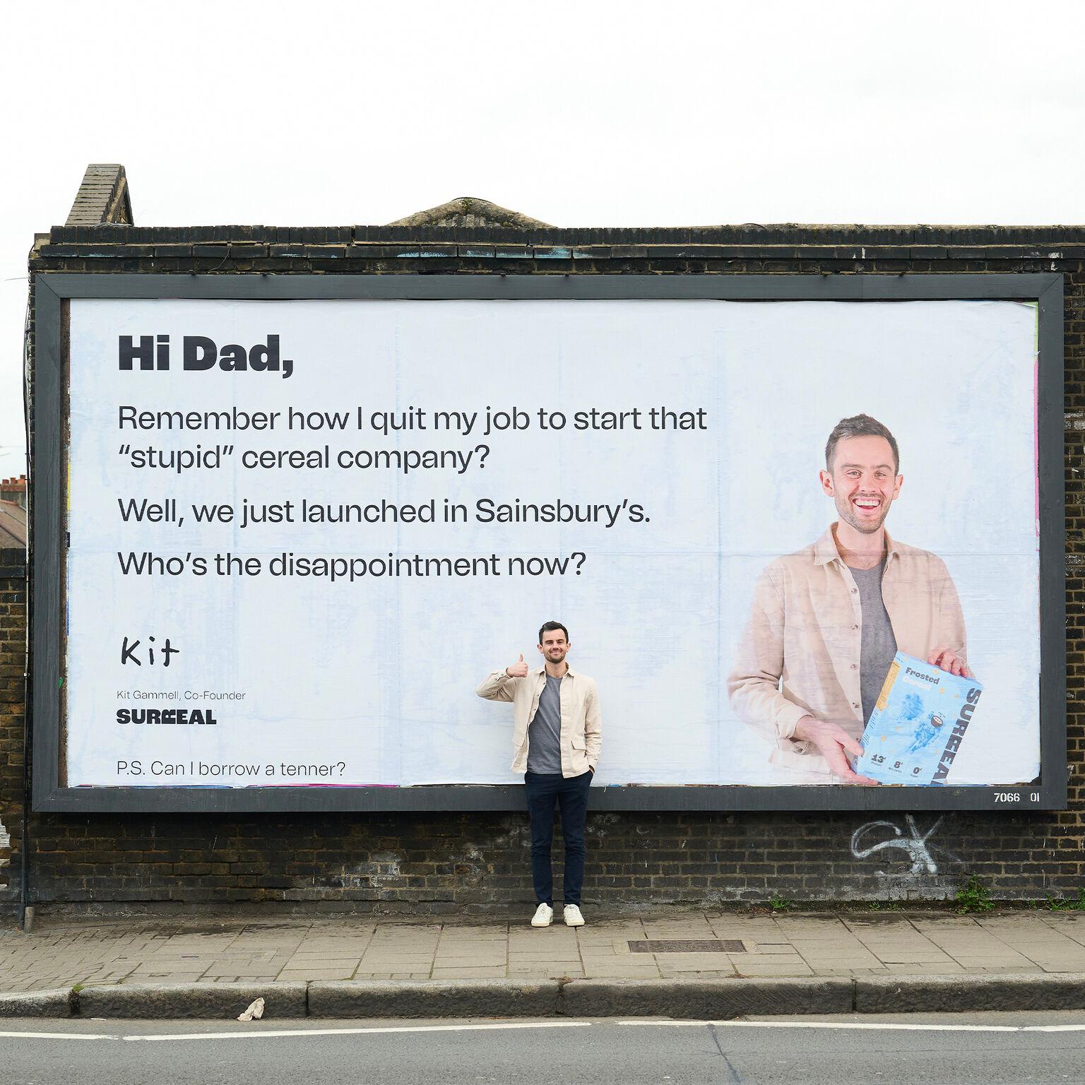 A man standing in front of a large billboard, representing the concept of brand voice and marketing strategies in the context of the article.