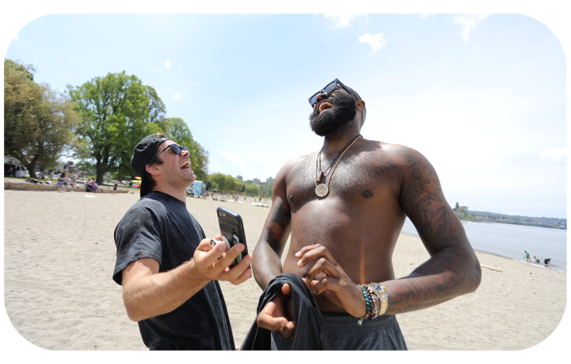 Two men engaging in a conversation on the beach, one without a shirt, symbolizing the personal and authentic connections formed in brand ambassador programs