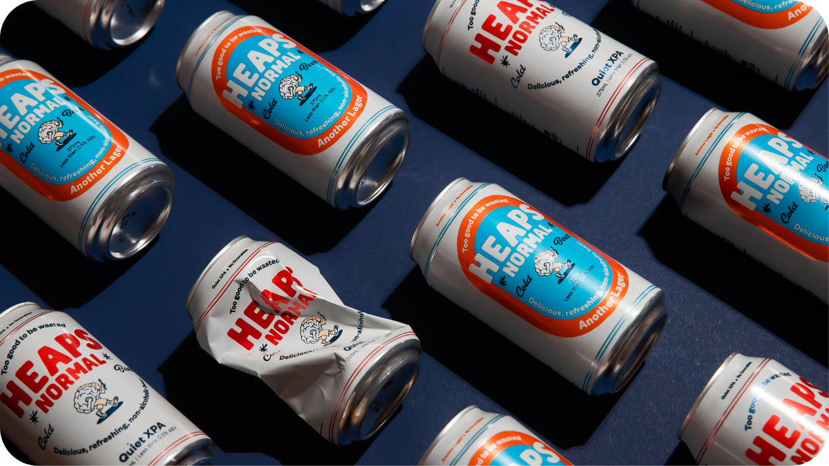 Several cans of Heaps Normal, a non-alcoholic beer brand, displayed on a table