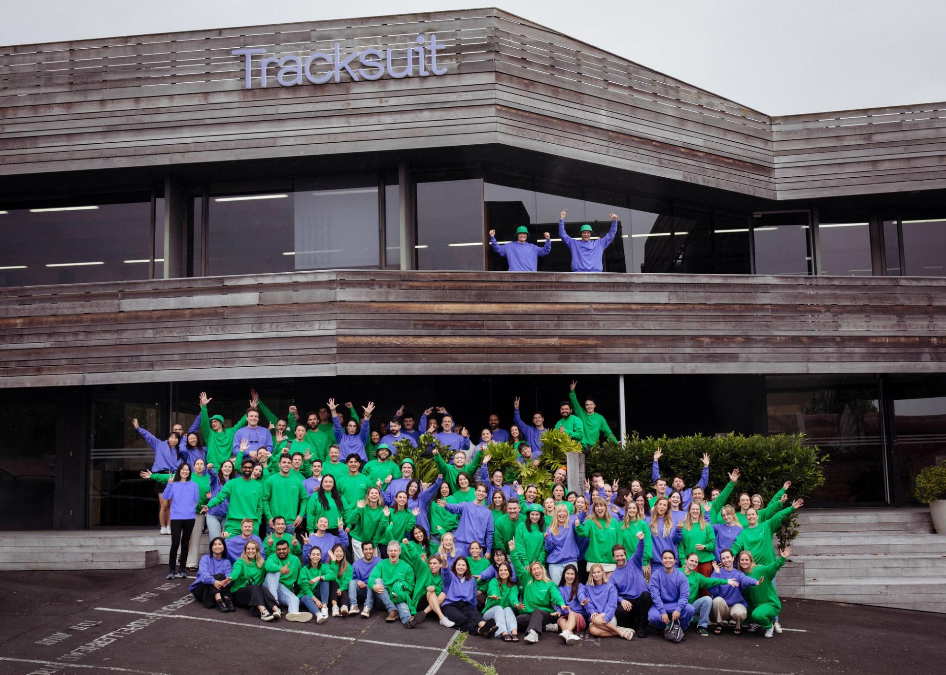a large group of people are posing for a picture in front of a building.