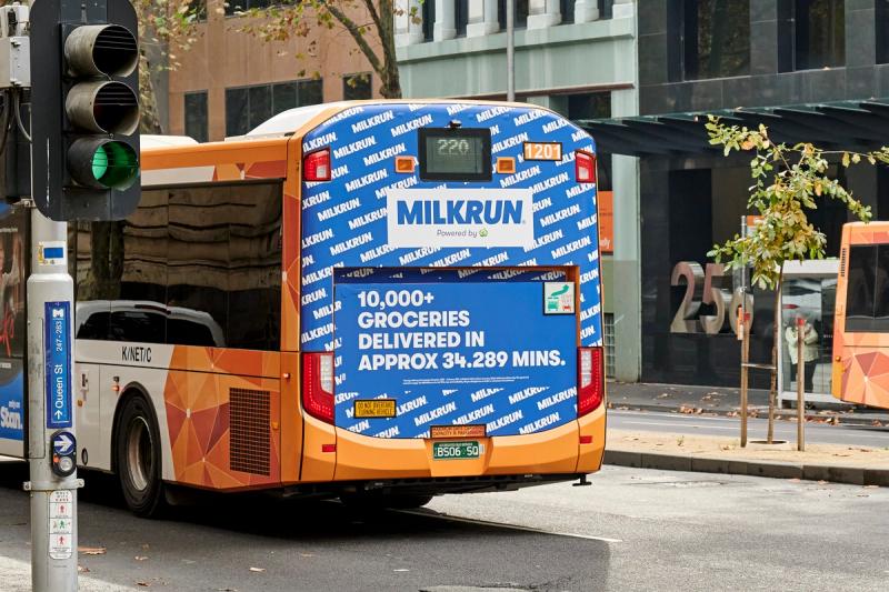 Back of a bus features a MILKRUN ad