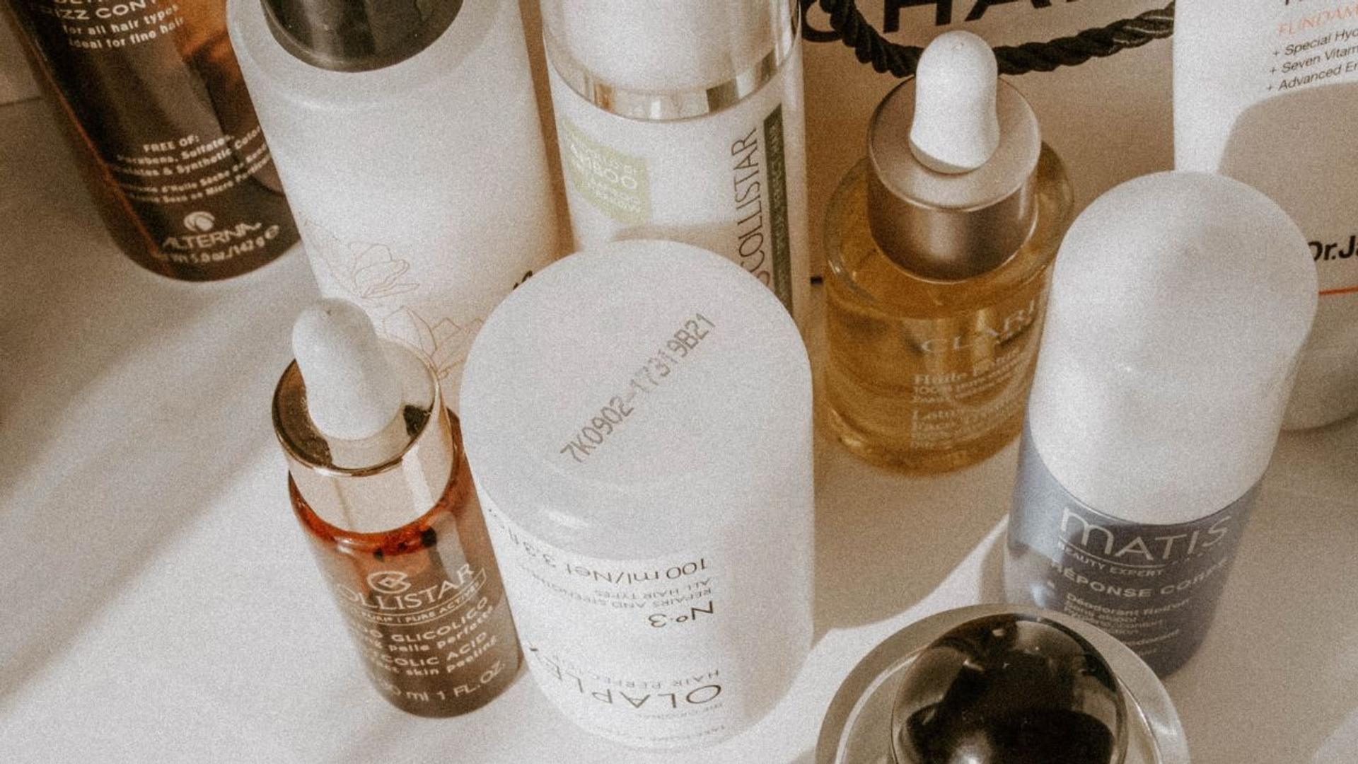 Some bottles of cosmetics sitting on a table.