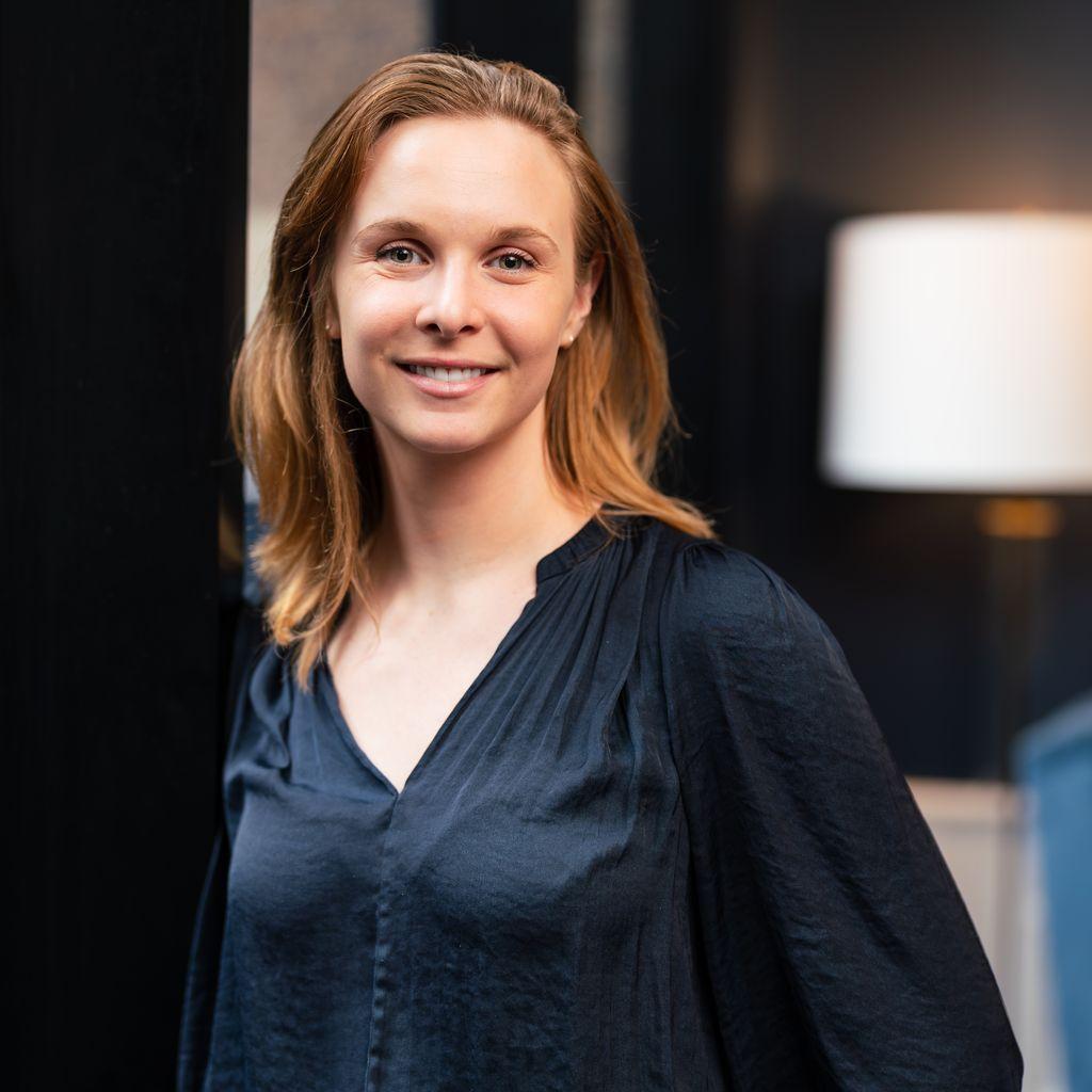 Toni Westlake, Head of Brand and Marketing at Big Red Group, smiling at the camera in a black shirt, representing her successful implementation of Tracksuit in their marketing strategy