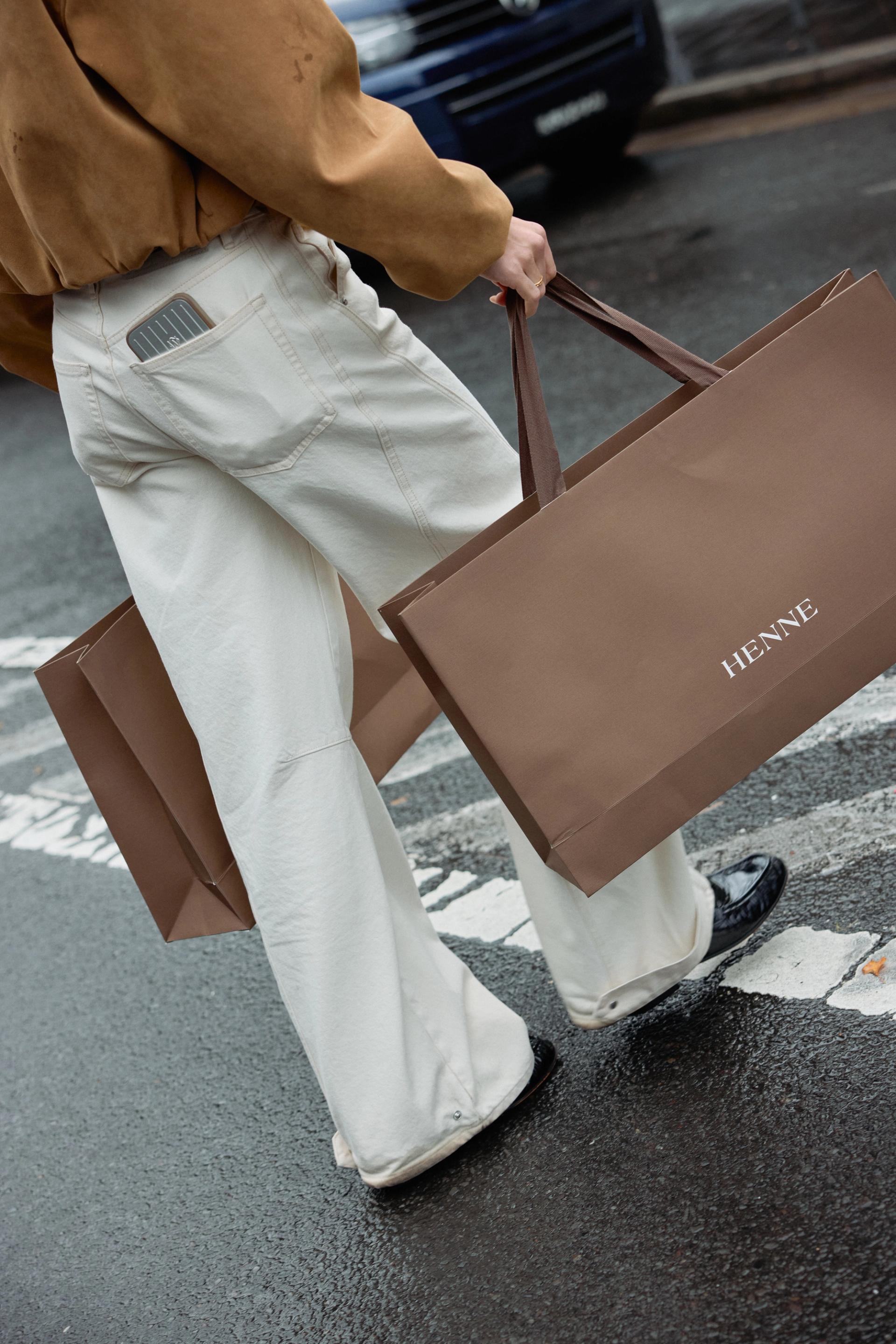 A customer happily carrying a Henne branded brown bag after shopping at the newly launched Henne store in Sydney