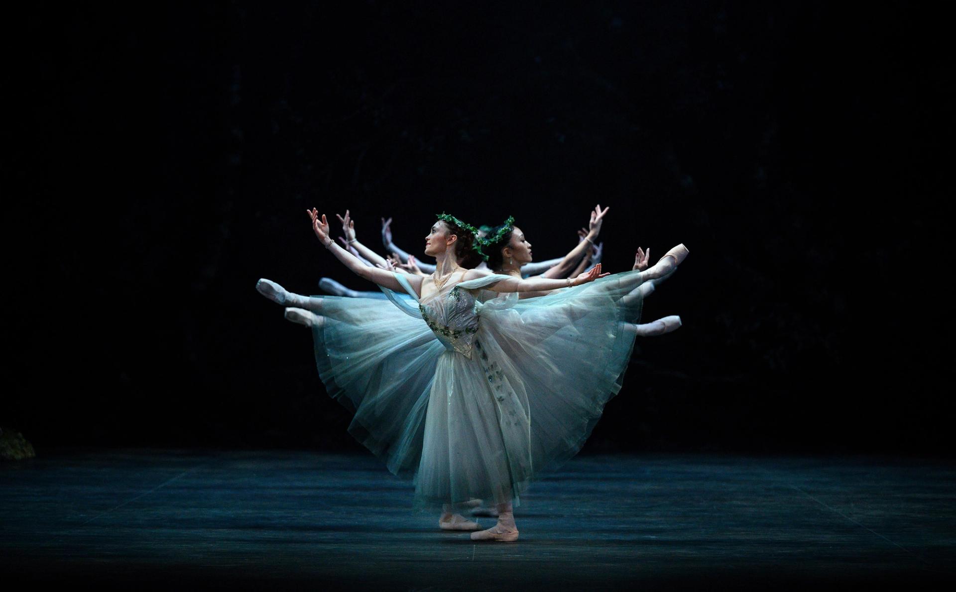 A group of ballerinas from the English National Ballet performing on stage, showcasing the company's commitment to artistic excellence and creativity.