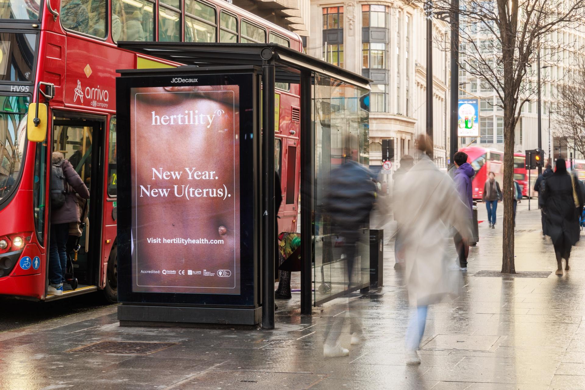 A bus stop advertisement for Hertility, a brand advocating for women's health and reproductive education, with the motivational text 'New Year, New U (Terus)' on it.