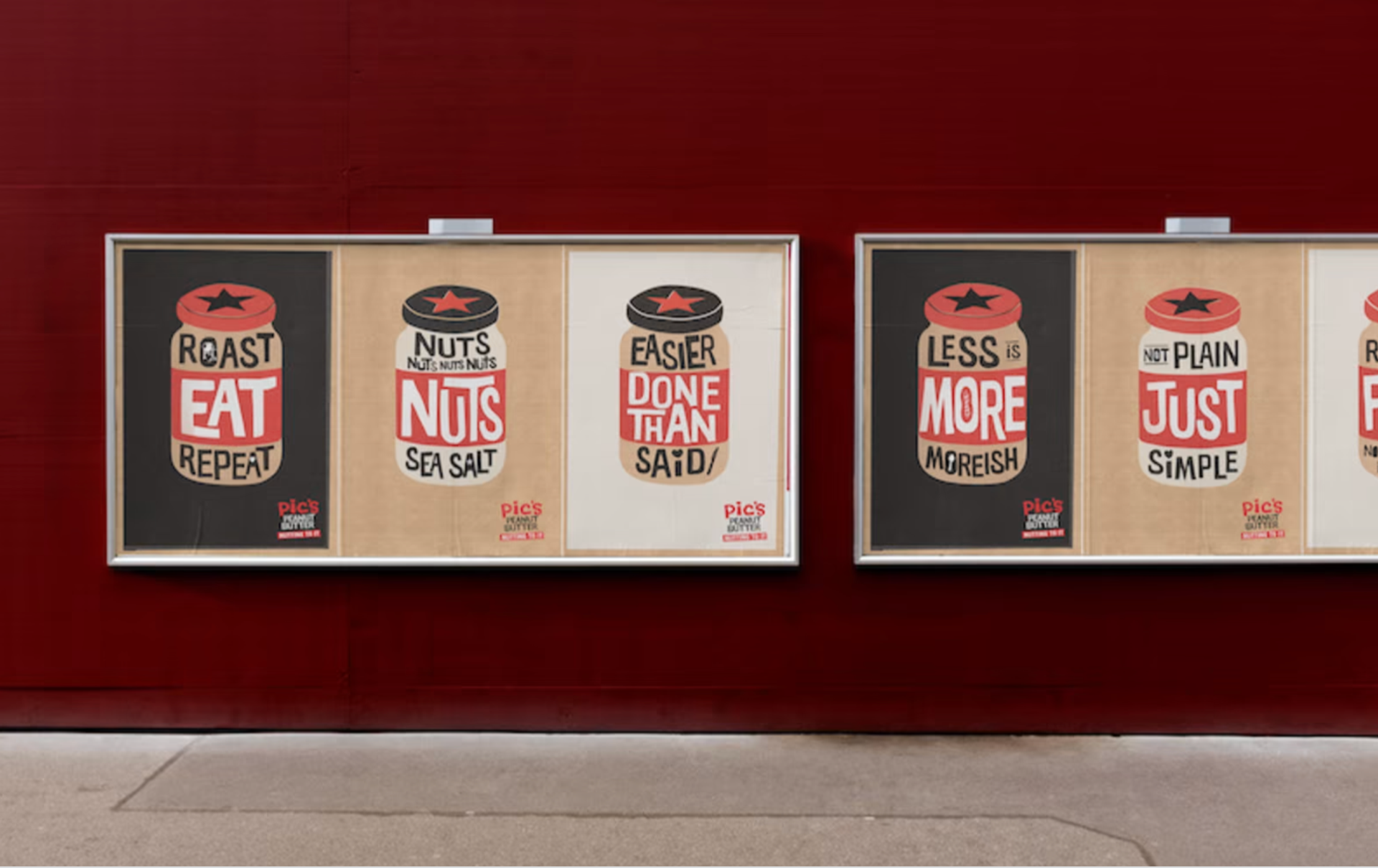 Four Pic's Peanut Butter posters on a wall that say roast, eat, repeat