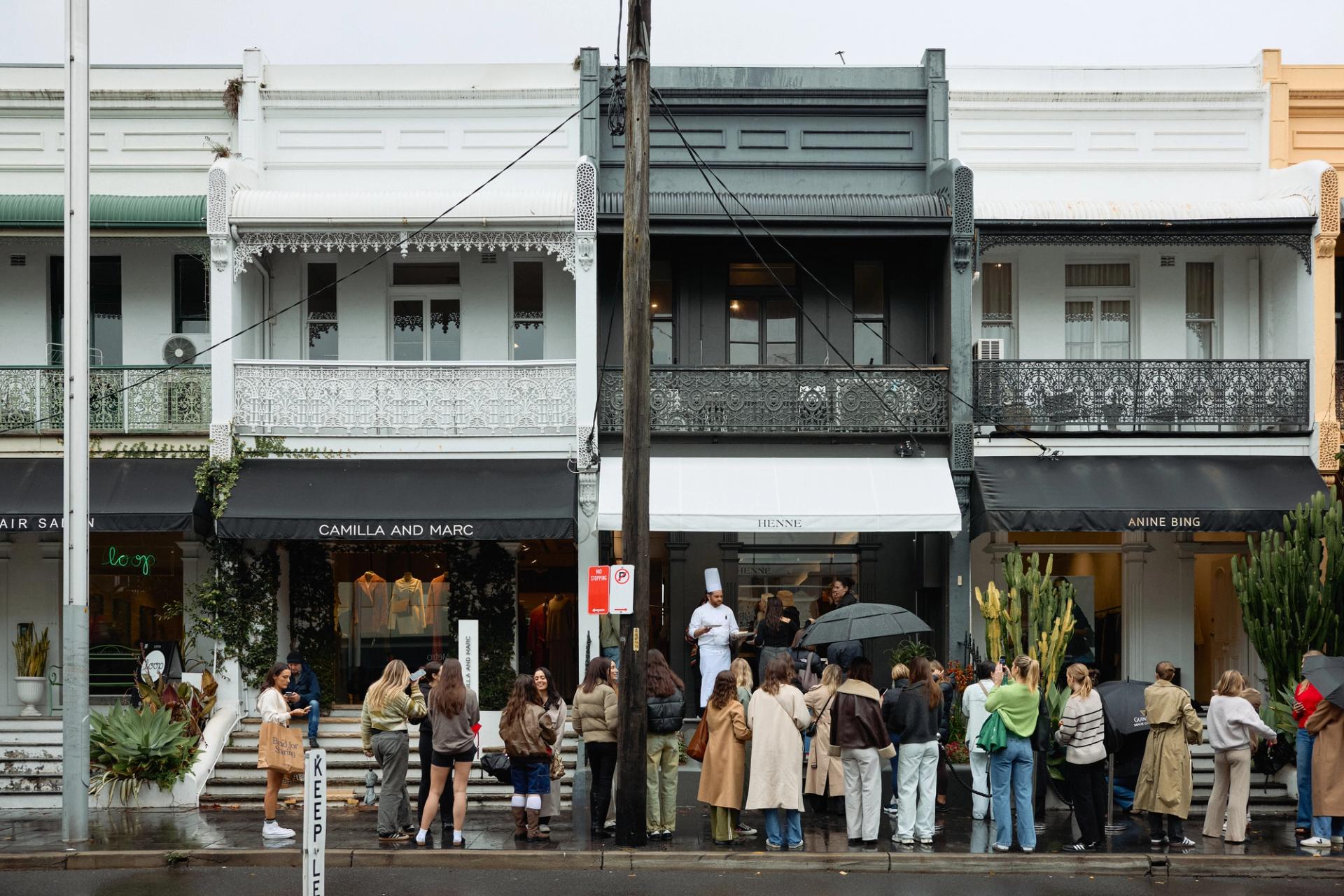 A crowd of people waiting outside the newly opened Henne store in Sydney, a significant milestone in the brand's expansion