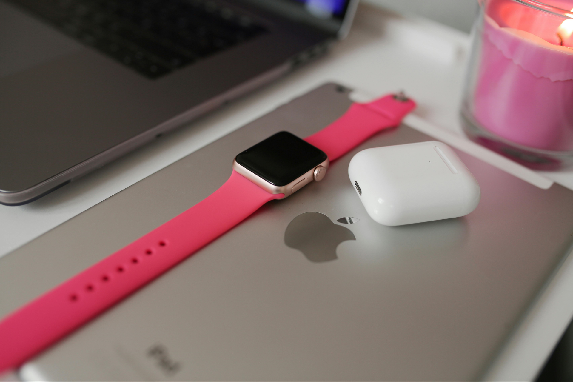 An Apple Watch displayed on top of an Apple iPad, symbolizing Apple's brand positioning as a premium tech company focusing on high-quality design and innovation
