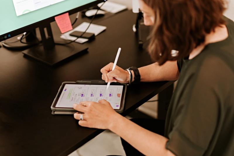 woman in office making notes on a tablet
