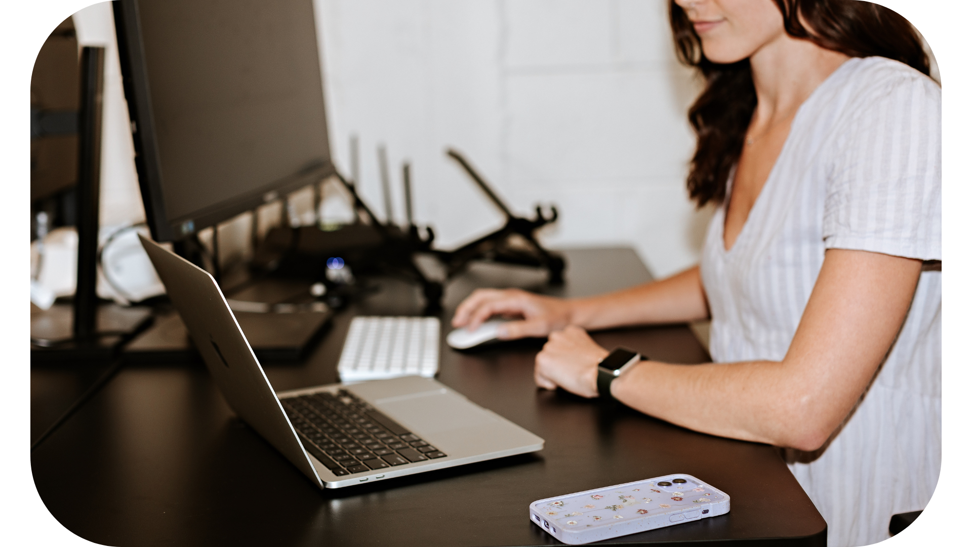 A focused woman conducting brand research on her laptop at her desk