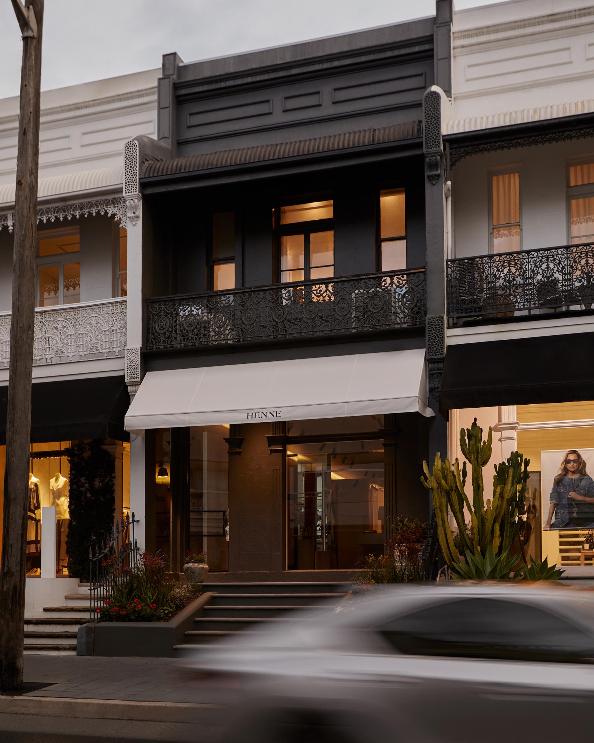 The exterior of Henne's first Sydney store, a black building with a white awning displaying the brand name 'Henne'.