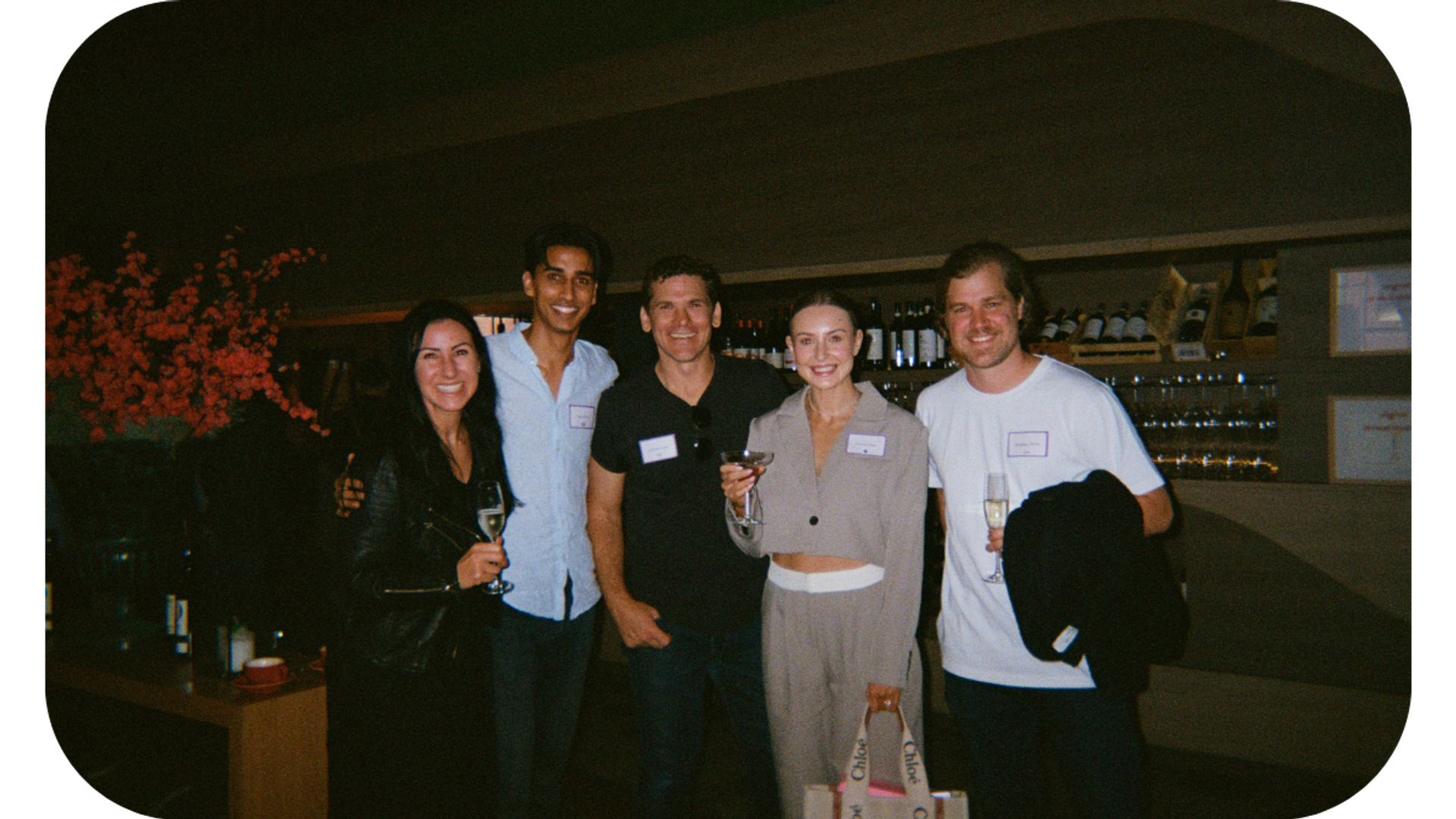 A group of professionals posing for a photo at a marketing event, with one individual prominently displaying a name tag labeled 'Amanda'.