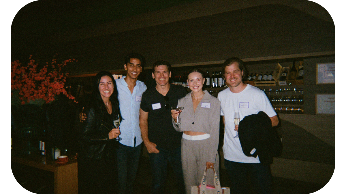 A group of professionals posing for a photo at a marketing event, with one individual prominently displaying a name tag labeled 'Amanda'.