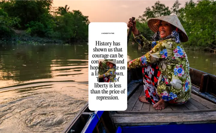 A joyful person in a colorful outfit and a conical hat paddles in a boat down a river at sunset. On top of this image, there’s a mobile screenshot with partially revealed text that says things like, “A Moment In Time” and “liberty is less than the price of repression”