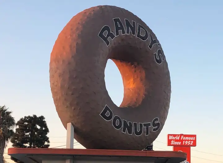 Giant donut on top of a donut shop